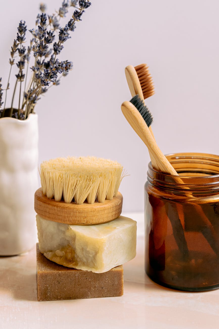 Luxurious wooden toothbrushes in a amber glass jar along with natural soaps